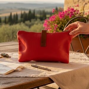 Grungier Italian leather wristlet pouch in bright orange and contrasting strap